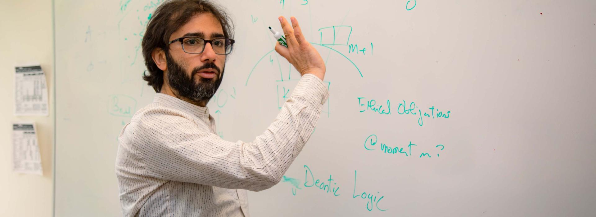 Researcher in front of a whiteboard. 