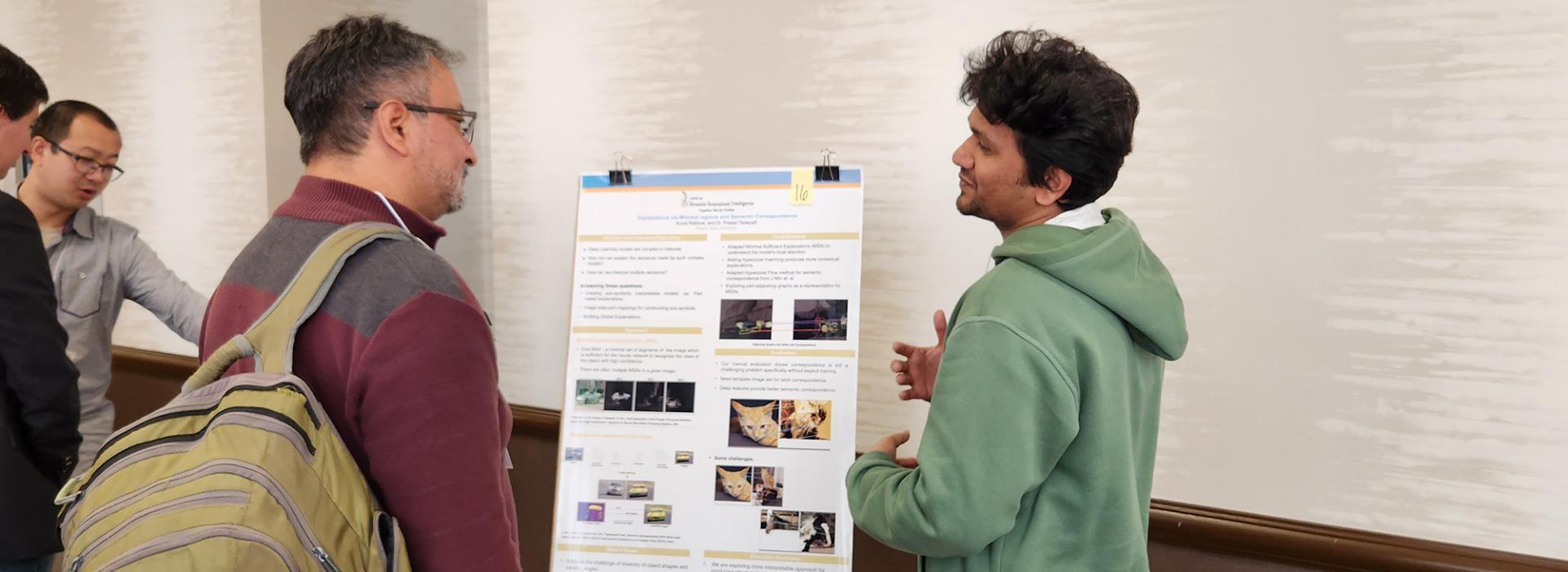 People looking at a research poster