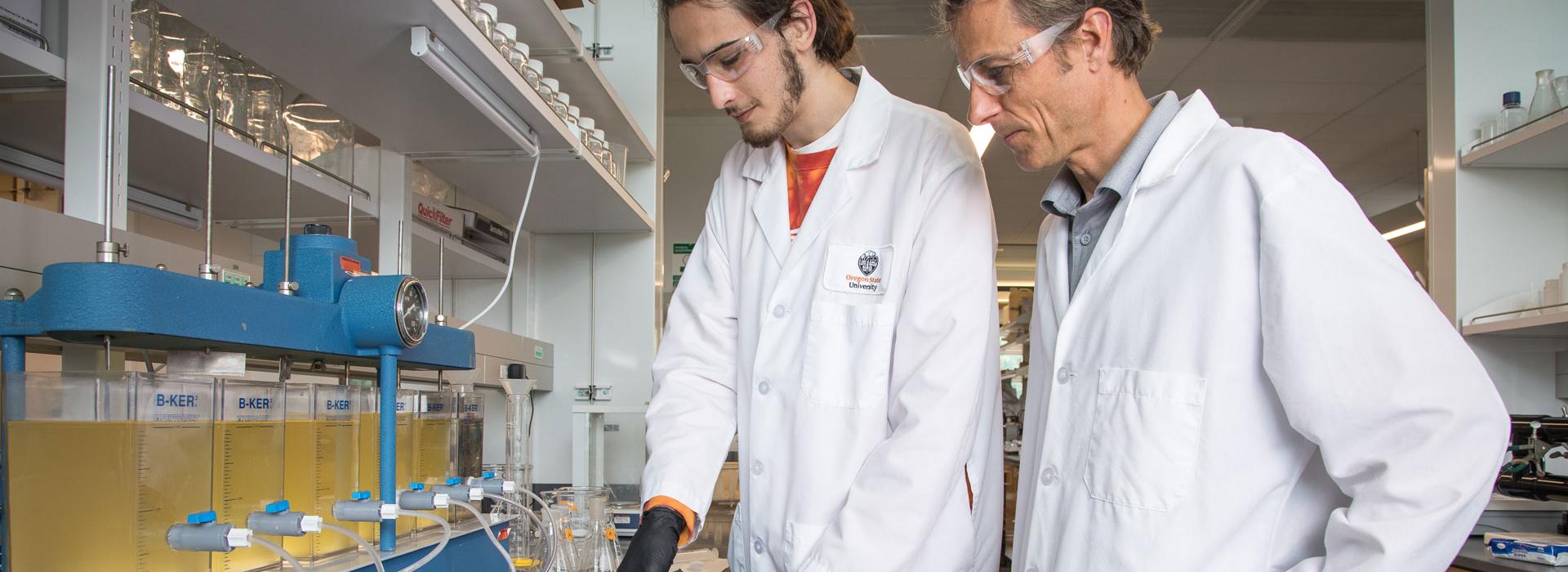Jeff Nason and student in lab uniform