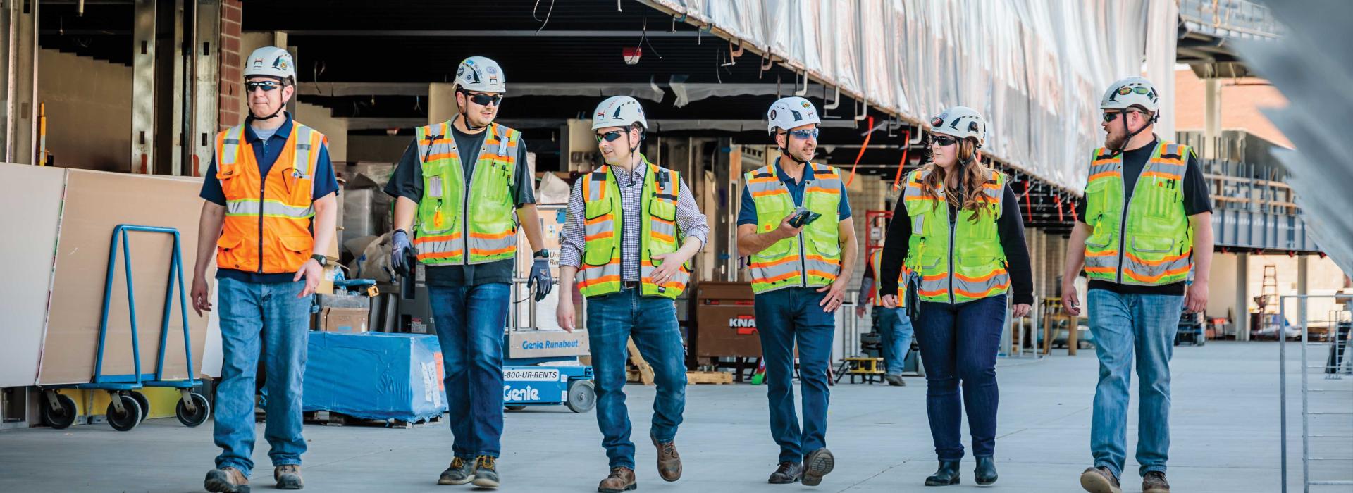 Civil Engineers in construction uniform walking together 