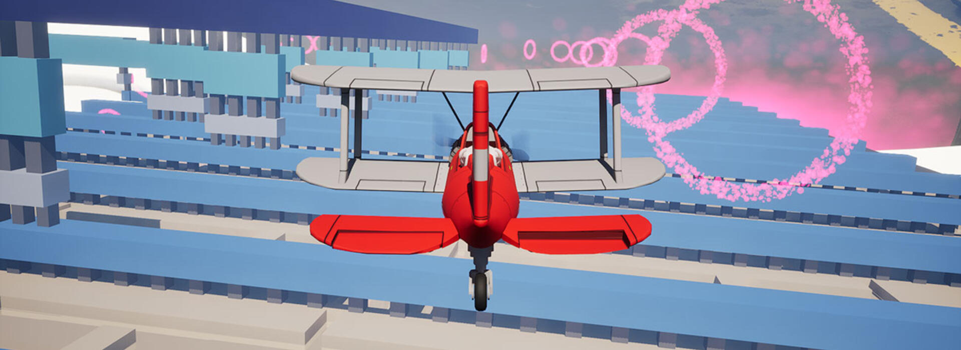 A red biplane flies forward through a stylized, computer‑generated cityscape of blue geometric buildings in a virtual environment.