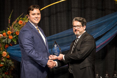 Will Mau accepts award