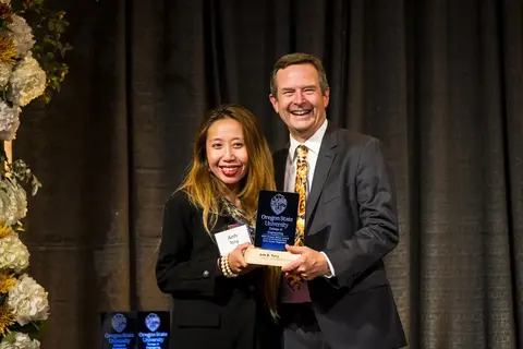 Anh Tong receiving an award from Scott Ashford.