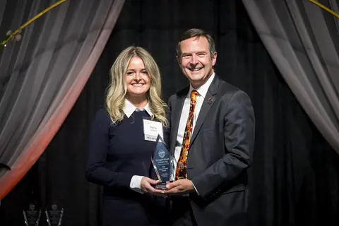 Dana Zottola recieving award from Scott Ashford.