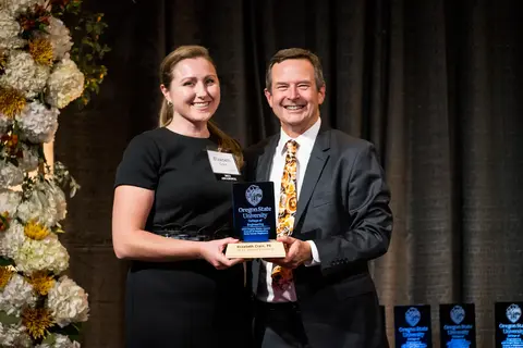 Elizabeth Crain receiving award from Scott Ashford.