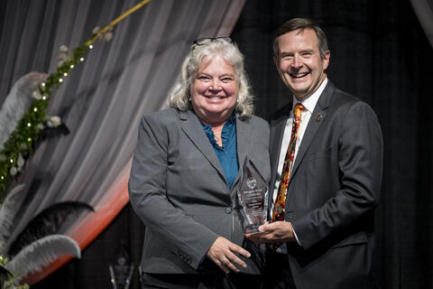 Rhonda Young receiving award from Scott Ashford.