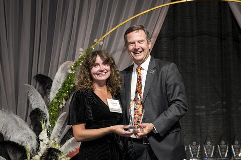 Sabrina Ireland receiving award from Scott Ashford.