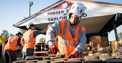 Three construction workers working outside.