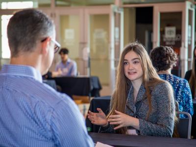 Students talking to teacher. 