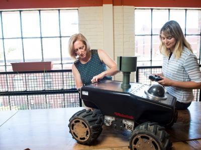 Faculty working on a robot.