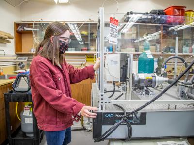 Student works with lab equipment.