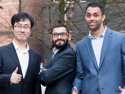 Three Oregon State engineering students standing together outside at the graduate research showcase