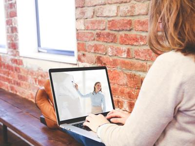 A person watching a presentation on her laptop.