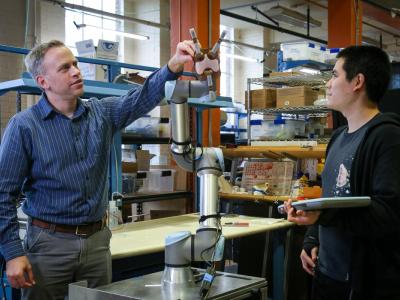 Faculty explaining his experiment to other faculty.