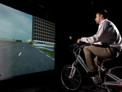 Faculty member using the simulated bicycle.