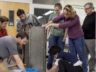 Group of students and faculty member working together