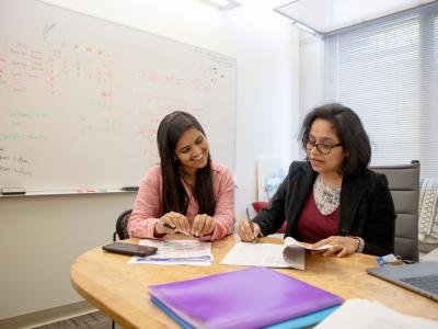 Anita Sarma and student working together at a table.