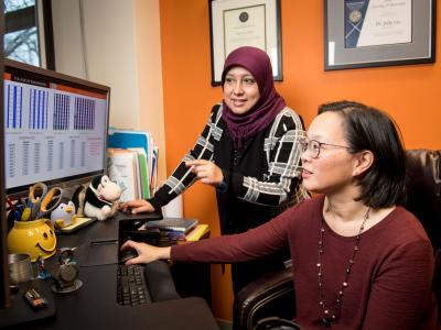 Faculty member Judy Liu and student in an office.
