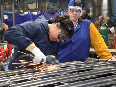 Two people engaged in job training.