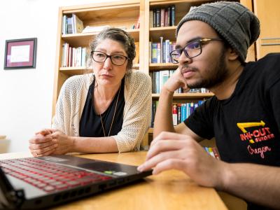 Jennifer Parham-Mocello and researcher at laptop.