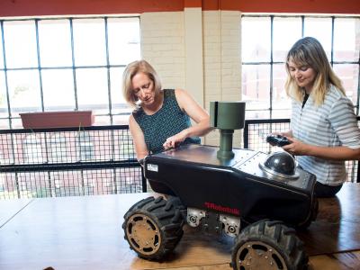Two faculty members in robotics lab.