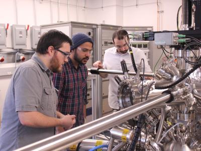 Engineers working on a machine at Northwest Nanotechnology Infrastructure site