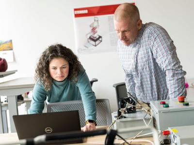 Student works in lab with faculty member Chris Hagen.