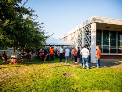 Guests attend the tailgate event in front of the Radiation Center.