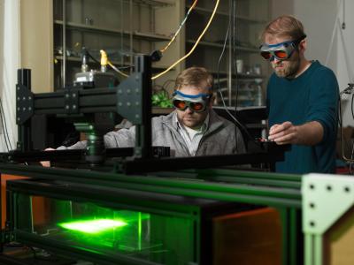 Faculty member Wade Marcum and researcher in nuclear engineering lab.