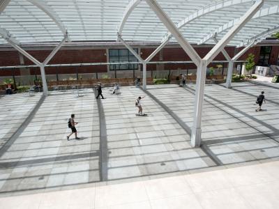 Students walk at the SEC Plaza.