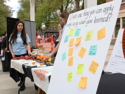 Students representing wellness health through a stand outside