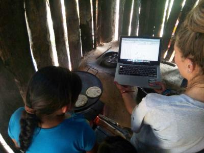 Lady showing girl a laptop