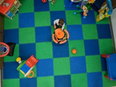 Toddler playing with a robot.